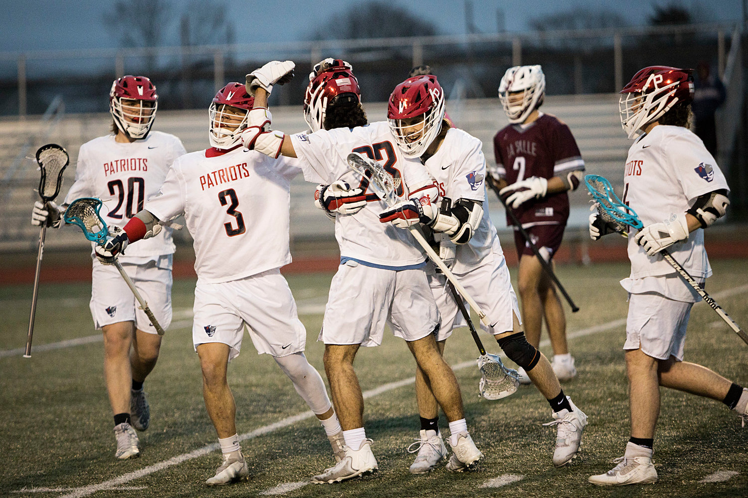 The Patriots celebrate tying the score up in the first quarter against La Salle.