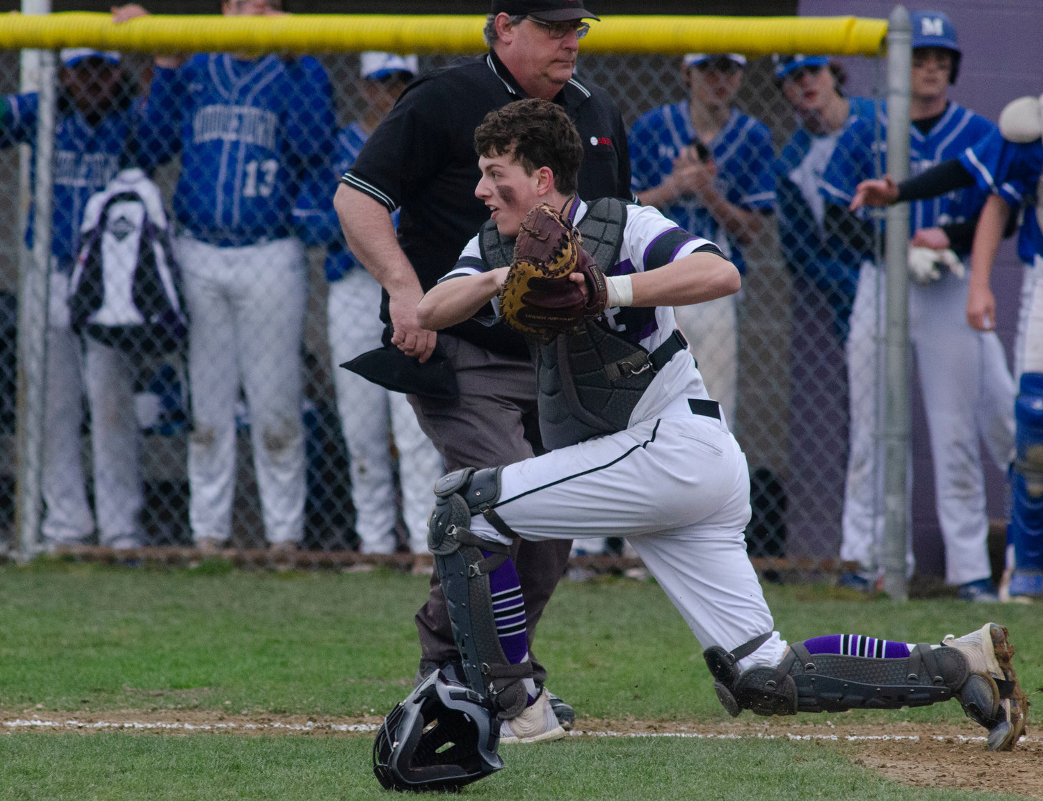 Catcher Matt Gale fields a throw to home plate and looks back a runner at first base. Gale drove in 5 runs in the series with Middletown including the game winner on Saturday.