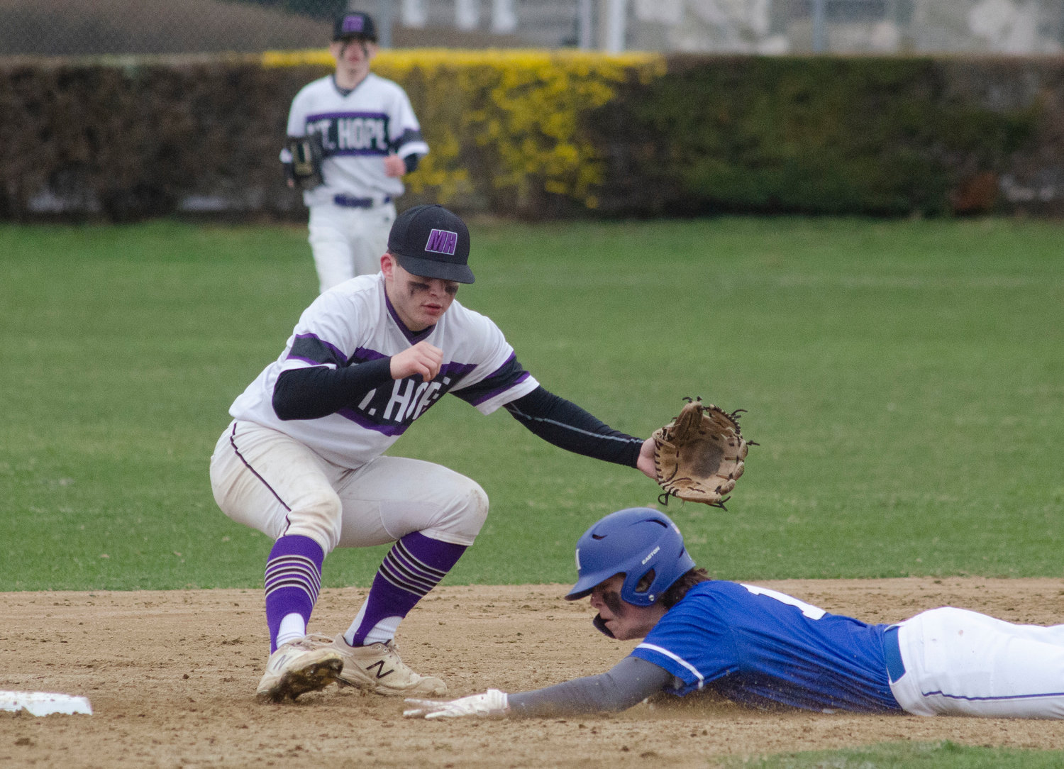 Second baseman Jack Standish fields a throw from catcher Matt Gale as they attempt to stop a Middletown steal. 