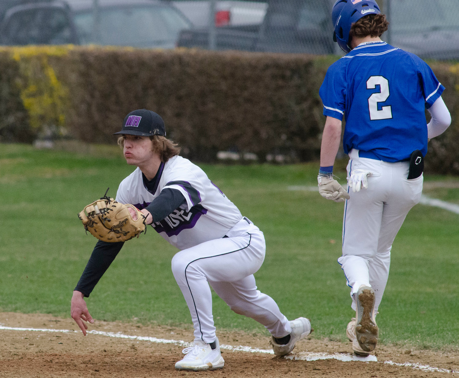 First baseman Brad Denson snares a throw from Parker Camelo to record an out at first base in the team's second game against Middletown at Guiteras Field.