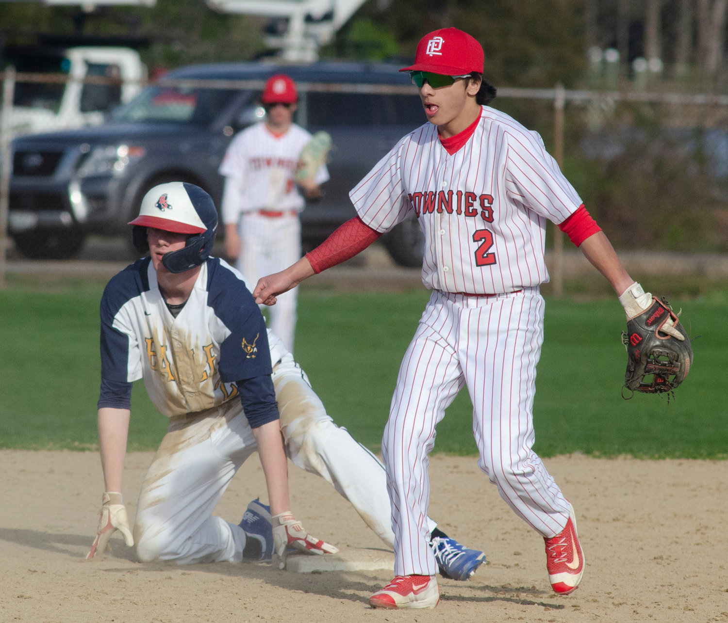 Second baseman Kyler Lorenz looks for the ball as it bounded off the runner during a Barrington steal.