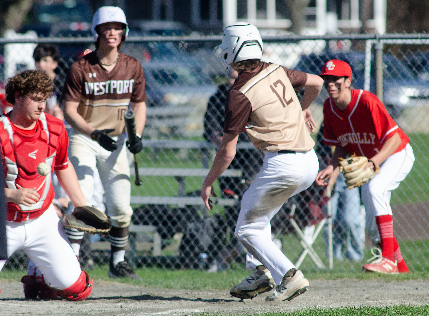 Noah Sowle (left) looks on as Cam Leary runs home to tie the game 1-1 in the bottom of the second inning on a double by Ben Boudria.