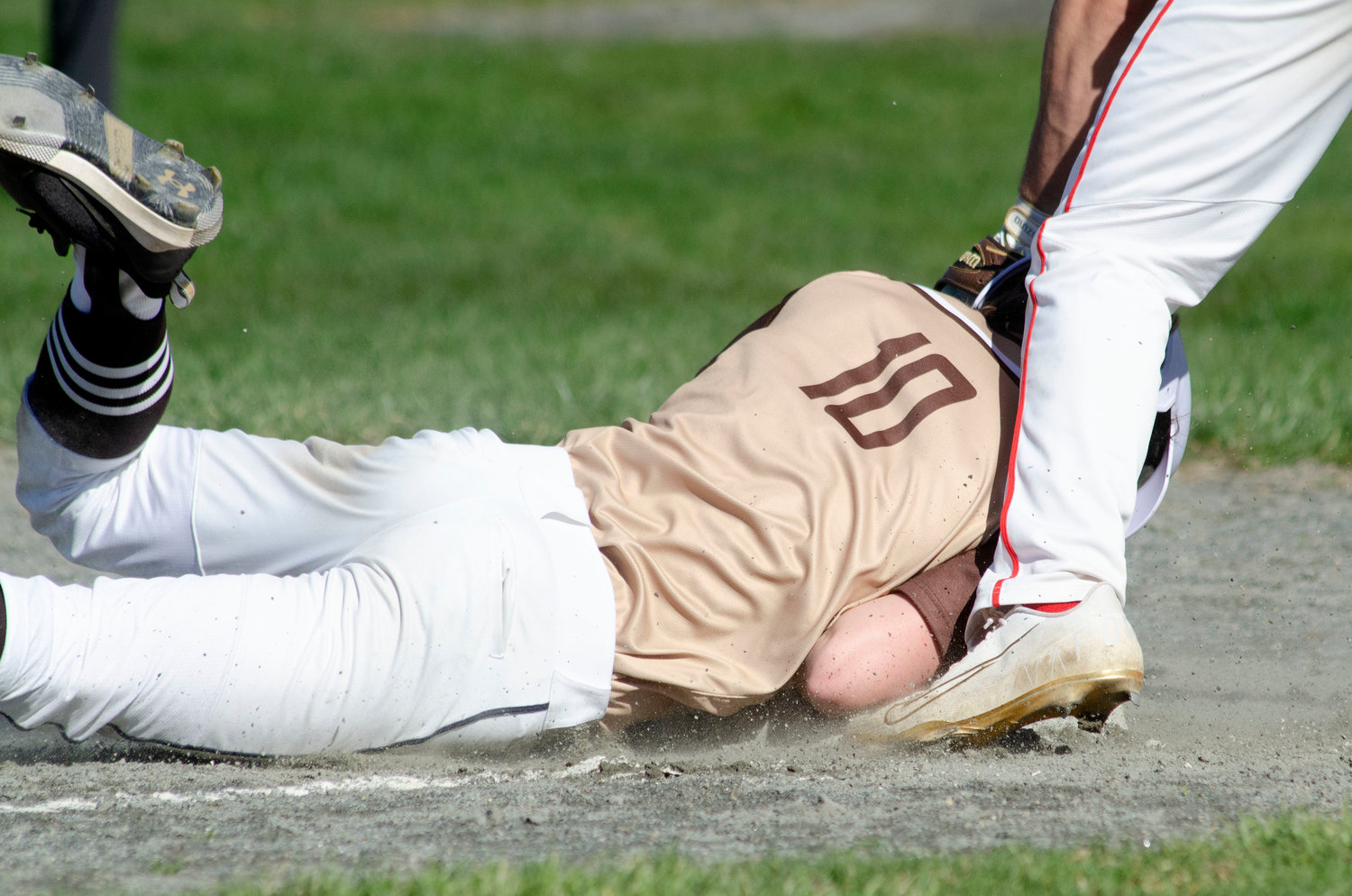 Noah Sowle steals third base and smiles at the Bishop Connolly bench after comments on his head first slide.