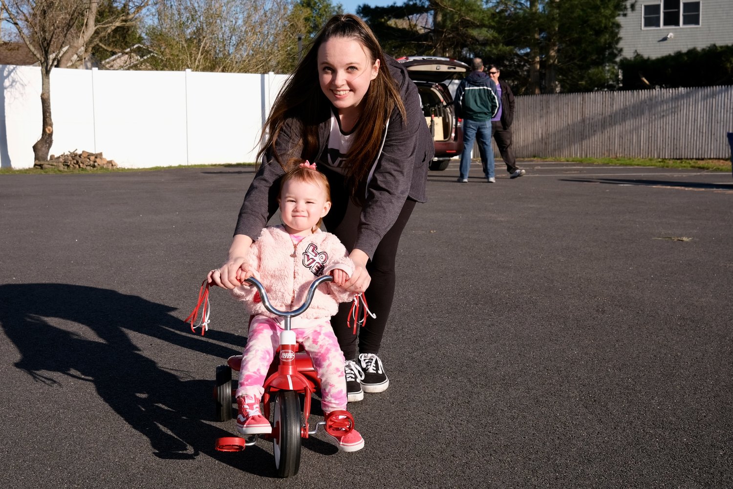 Noelle Vierkant, 2, gets a push from her mom, Kelsey Preble, as she pedals around the parking lot of the CFP Arts, Wellness, and Community Center during a Bike Safety Forum on Wednesday, April 20.