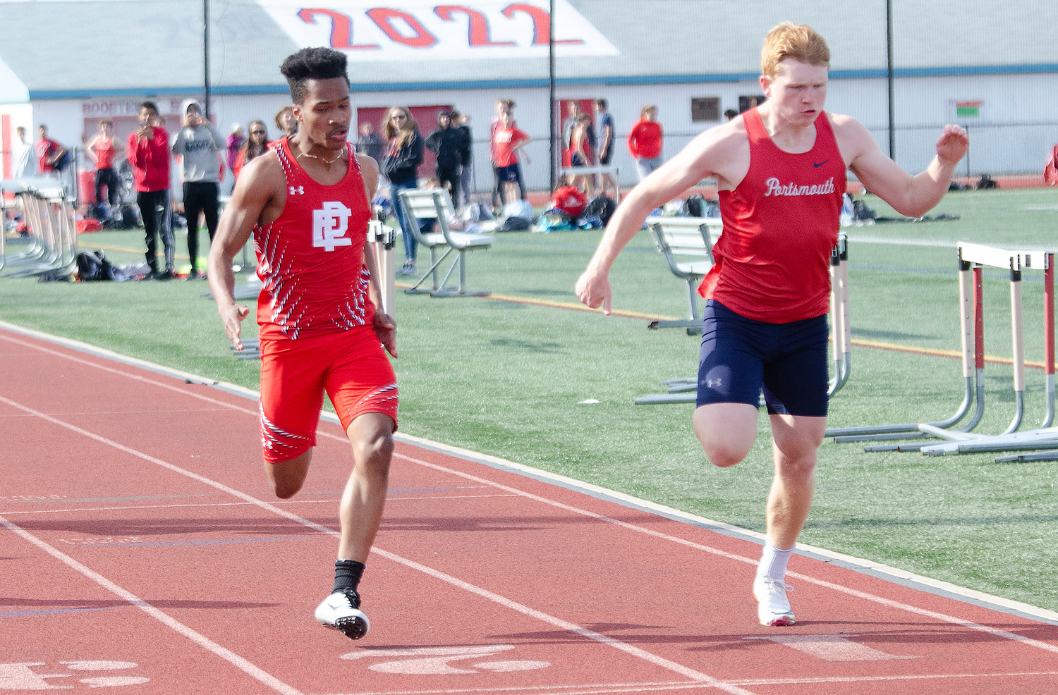 Portsmouth’s Colby Fahrney (right) nips Kit Ruddick at the finish of the 100-meter dash. Fahrney won with a time of 11.6 seconds.