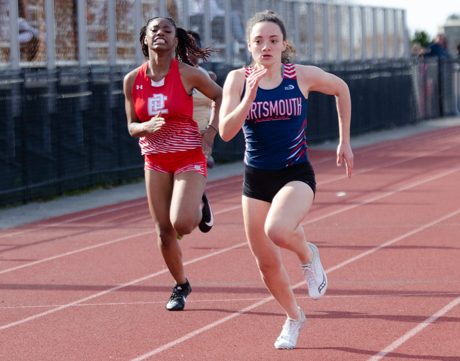 The Patriots’ Elly Skeels on her way to winning the girls’ 100-meter dash in a time of 13.4 seconds.