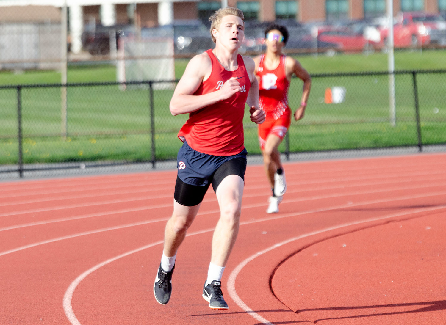 The Patriots’ Jeff Brady rounds the corner on his way to winning the 400-meter run in a time of 52.1 seconds.