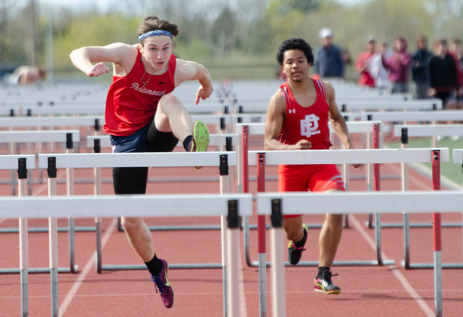Maciej Tabak of PHS (left) and Denzy Suazo of East Providence race in the 110 -meter hurdles, won by Tabak in a time of 18.5 seconds.