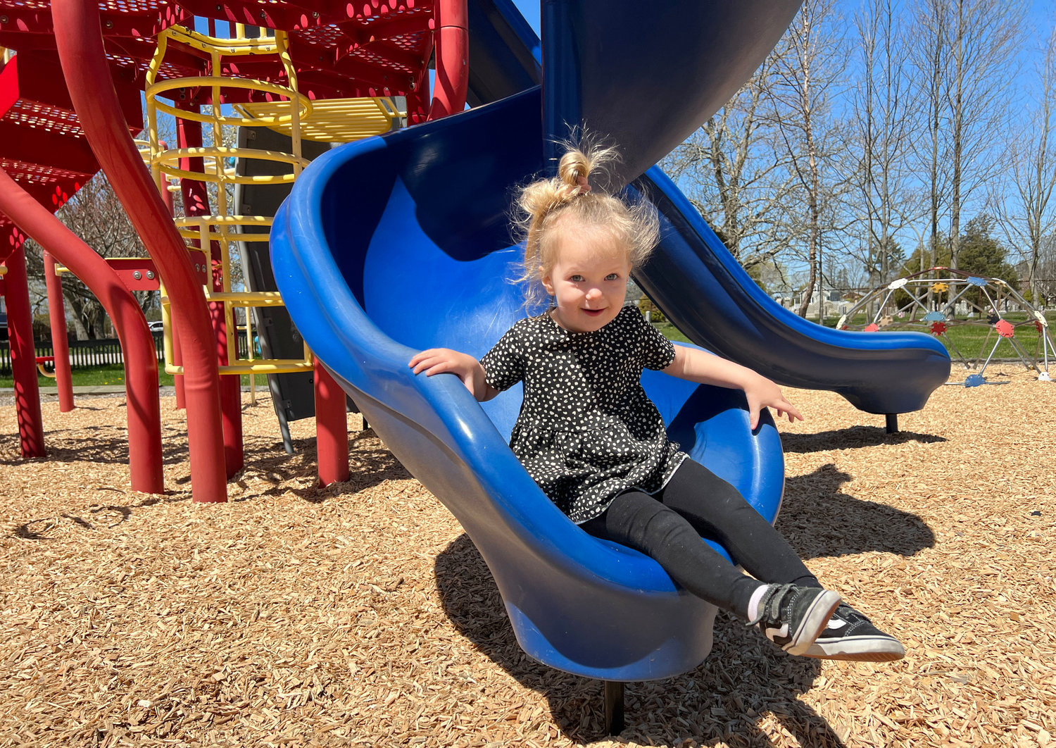 Lola Costa, 2, plays on the Turnpike Avenue playground on Friday morning. A group of parents has received permission to pursue funding for a plan to completely rebuild the playground.