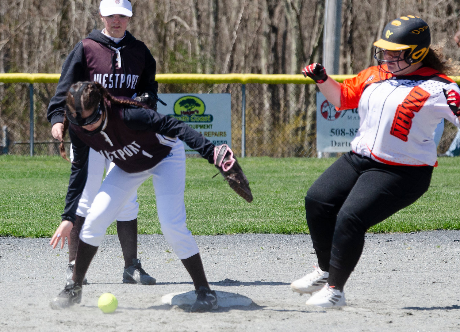 Shortstop Julia George fields a grounder up the middle with second baseman Isabel Berube as a Diman runner runs to second base.