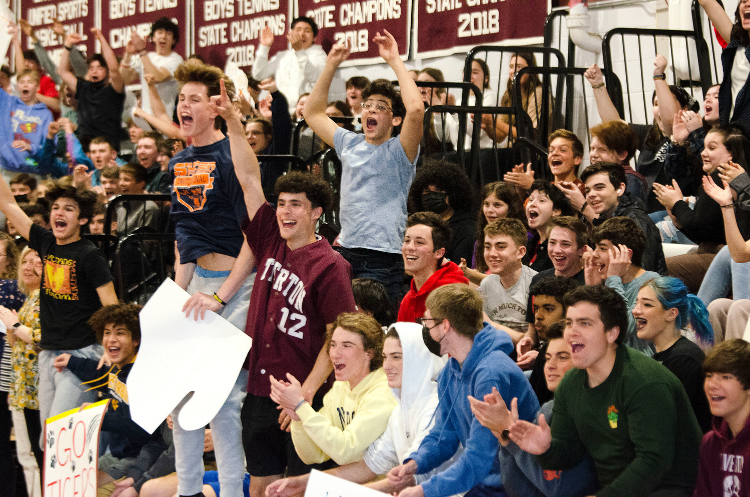 Jason Potvin (mid-left), Jordan Panell (in maroon) and the crowd cheer after crowd favorite Aidan McCrosson makes a basket. 