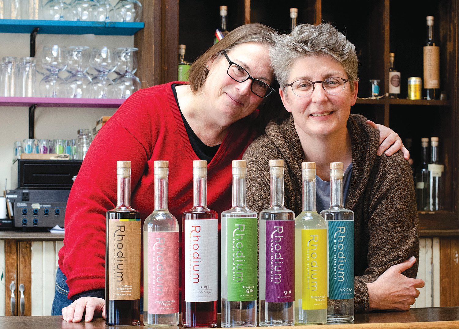 Spouses Cathy Plourde (left) and Kara Larson launched their first professional venture together three years ago. Their Rhode Island Spirits products are now being sold in restaurants and package stores throughout Rhode Island, and they are beginning to work on expansion into Massachusetts.