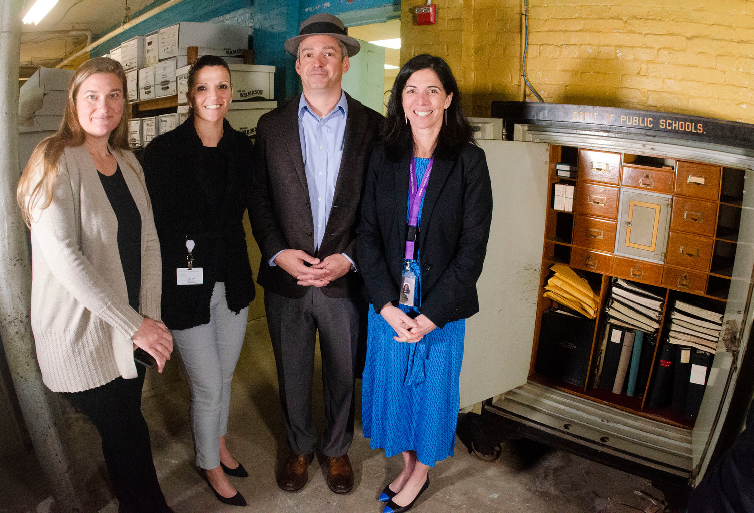 Bristol town treasurer Julie Goucher, town clerk Melissa Cordeiro, town administrator Steve Contente and superintendent Ana Riley pose for a photo after cracking open a safe in the basement of the old Oliver School.