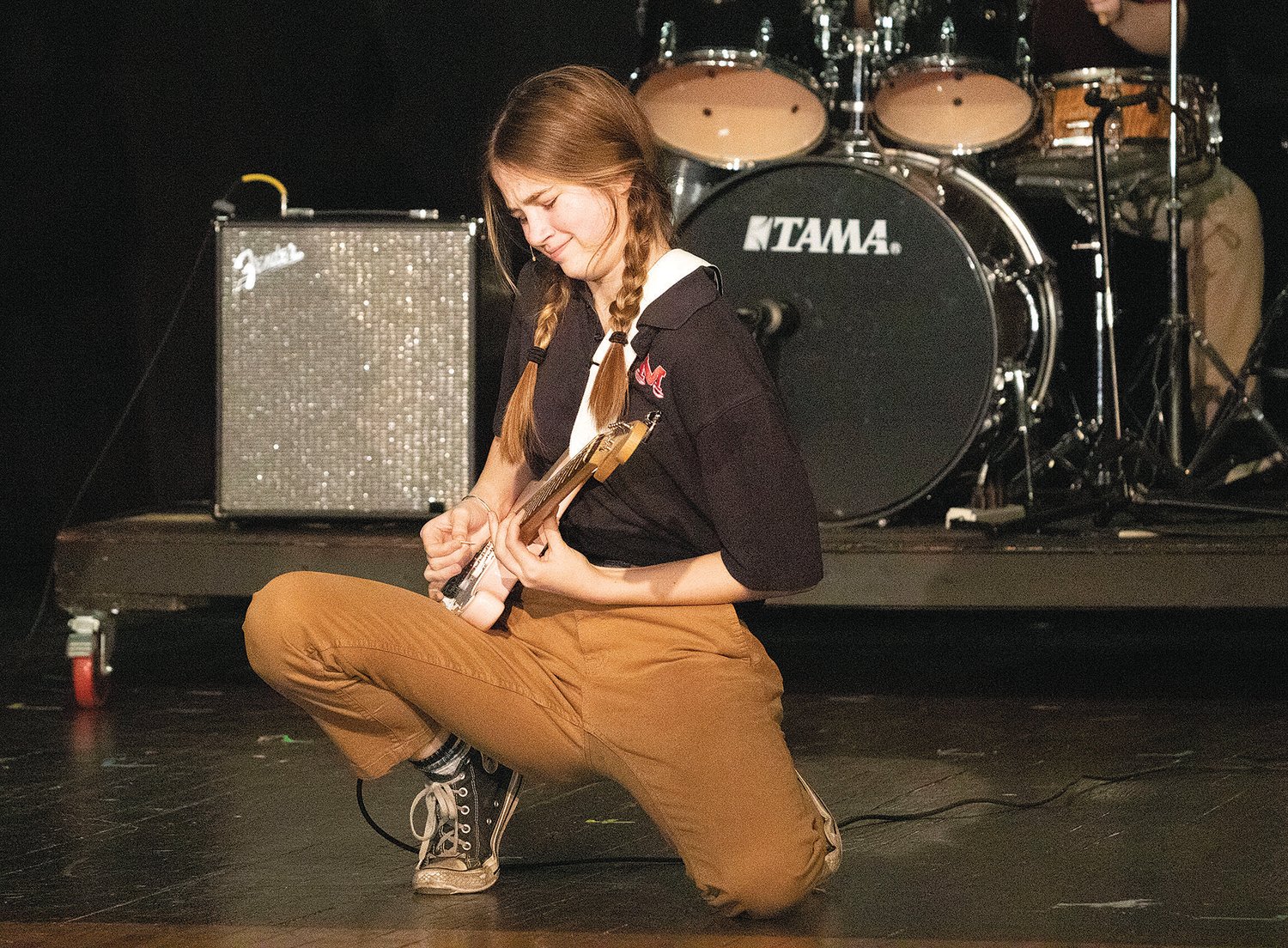 Casey Ruth Little shreds during a rehearsal of “School of Rock” at Mt. Hope High School.