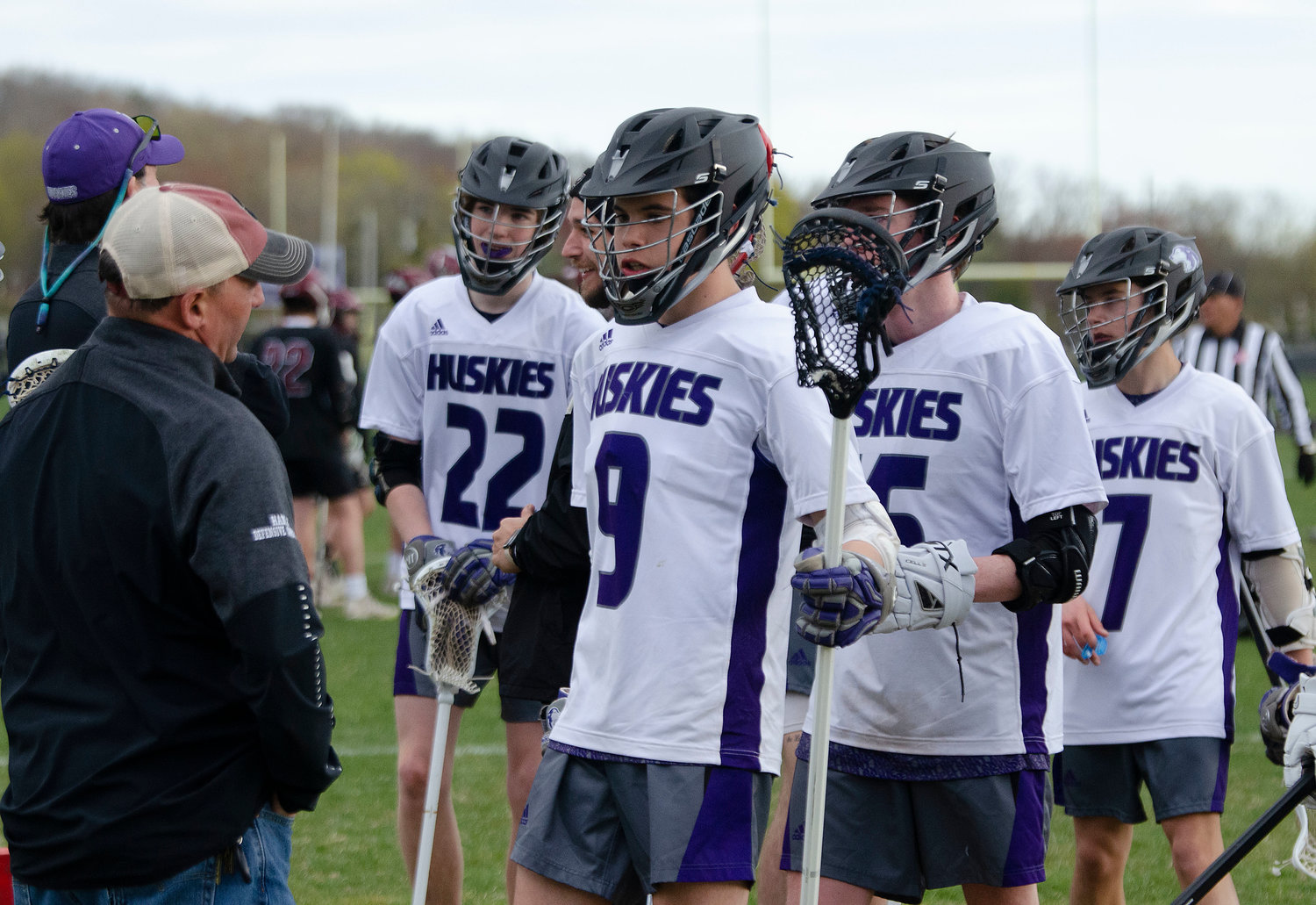 Assistant coach Ted Hanley (left) speaks to Riley Spina (mid-left), Colin Dos Santos, Gordon Kopecky and others during a time out.