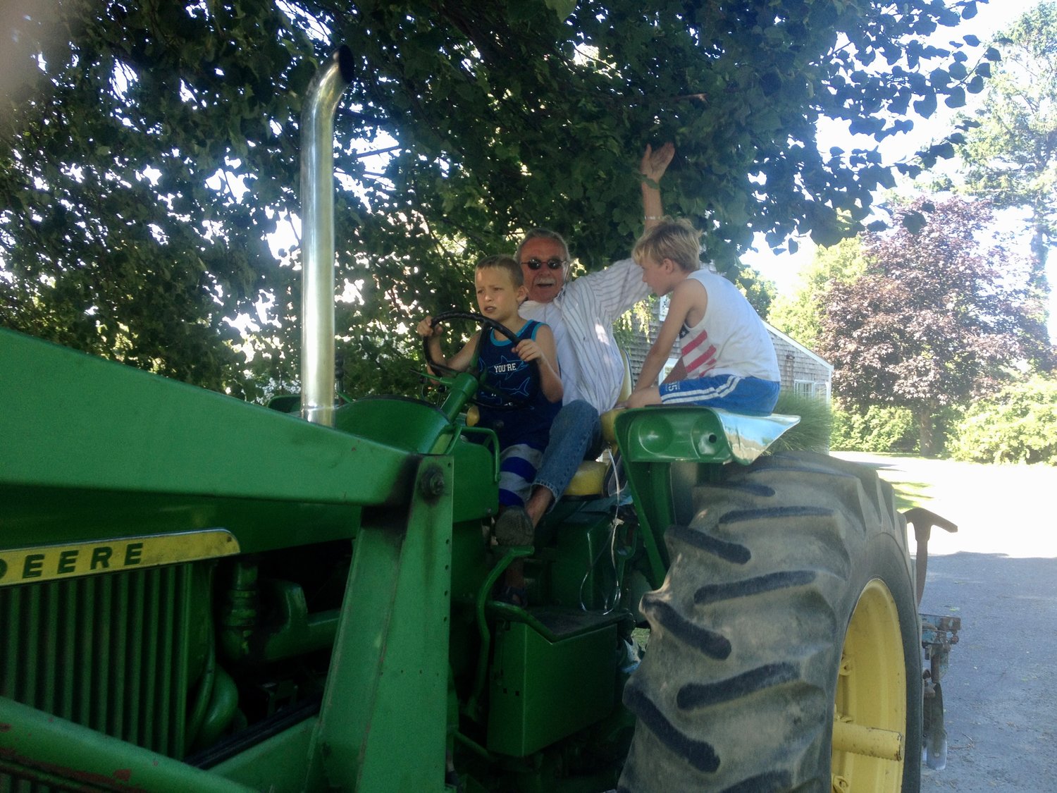 Coll Walker gives some of his grandchildren a ride in a tractor in this family photo.