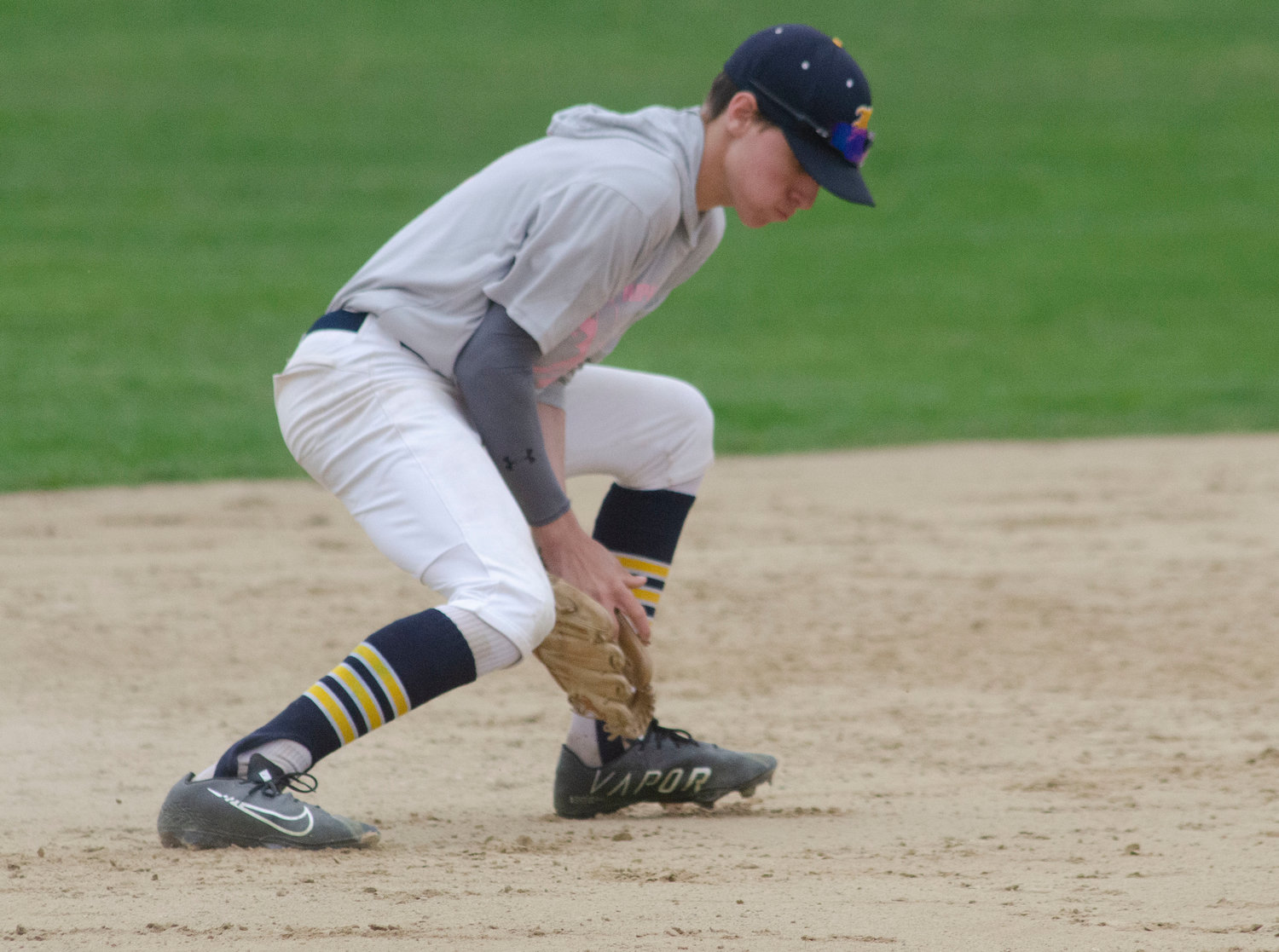 Barrington High School shortstop Gabe Tanous scoops up a grounder during Friday’s game against Mt. Hope. The two teams used the game as a fund-raiser for the Jimmy Fund, collecting more than $5,000 in donations.