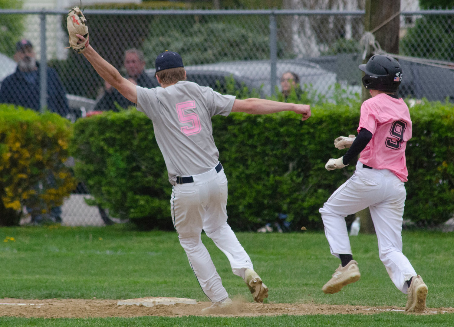 Barrington High School first baseman Nick Scandura beats Huskies second baseman Ethan Santerre to the bag for an out after taking a throw from a teammate. The two teams used the game as a fund-raiser for the Jimmy Fund, collecting more than $5,000 in donations.