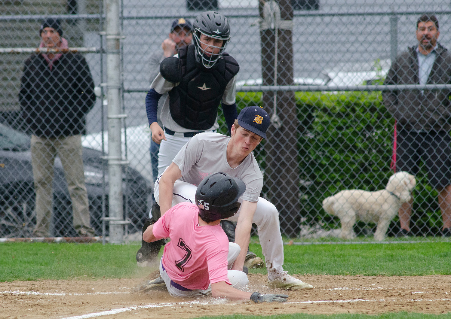 Eagles pitcher Harrison Cooley slaps a tag on Huskies runner Dayton Van Amberg attempting to reach home on a passed ball.