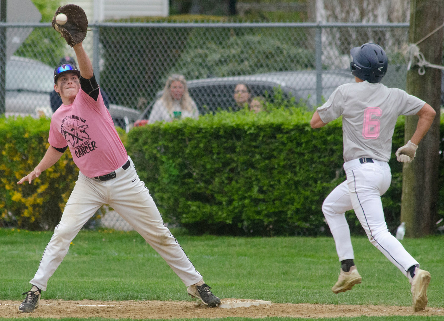 Matt Gale stretches to catch a throw by shortstop Dayton Van Amberg to beat Barrington runner JT Celico for an out during the Huskies Strike-Out Cancer fundraiser game on Friday.