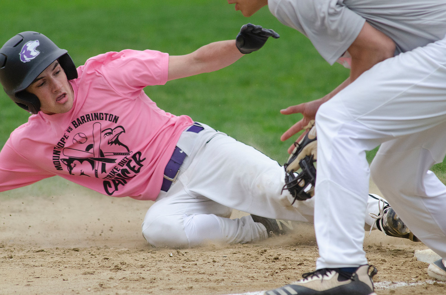 Dayton Van Amberg slides safely into third base after a teammate's hit to centerfield.