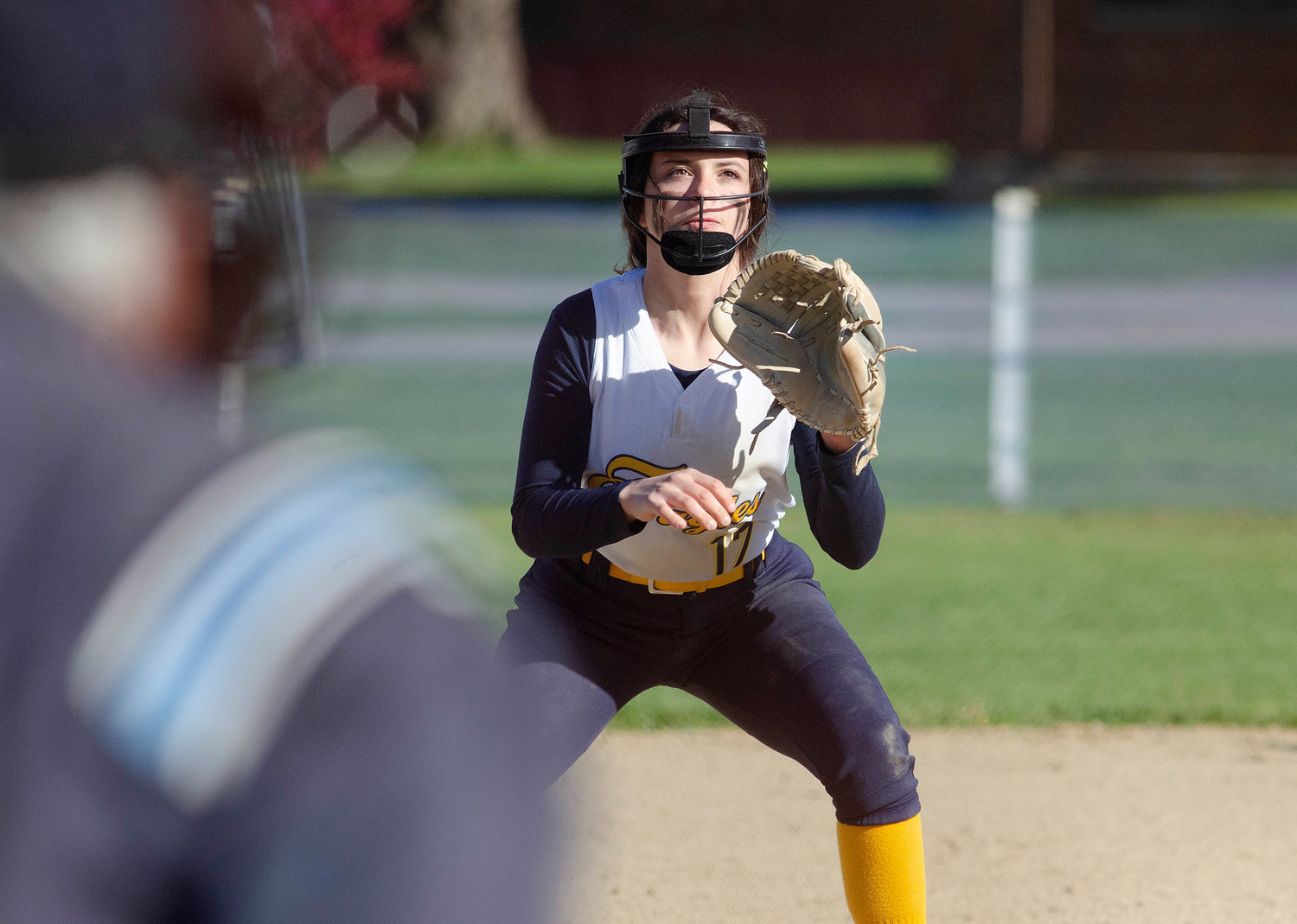 Barrington third baseman Ariana Renzi looks in at the batter as teammate Ace McCoy makes a pitch.