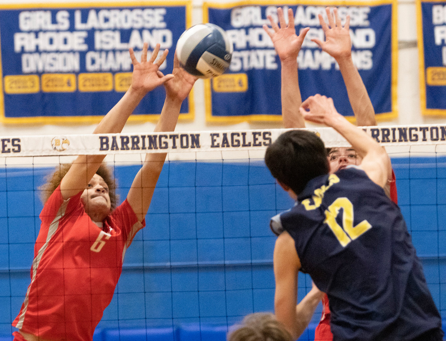 East Providence High School’s Franklin Carela Lopez (left) and Brett Schwab block a shot attempt by Barrington during the Division II boys’ volleyball match hosted by the neighboring Eagles Thursday night, May 5.