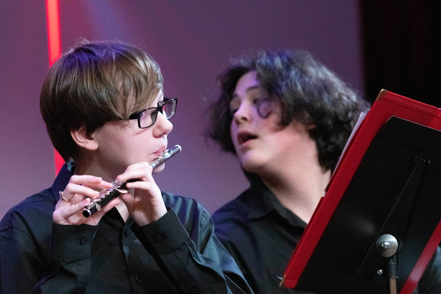 Jorden Pereira warms up on the flute as band mate Jake Rodrick (right) looks on