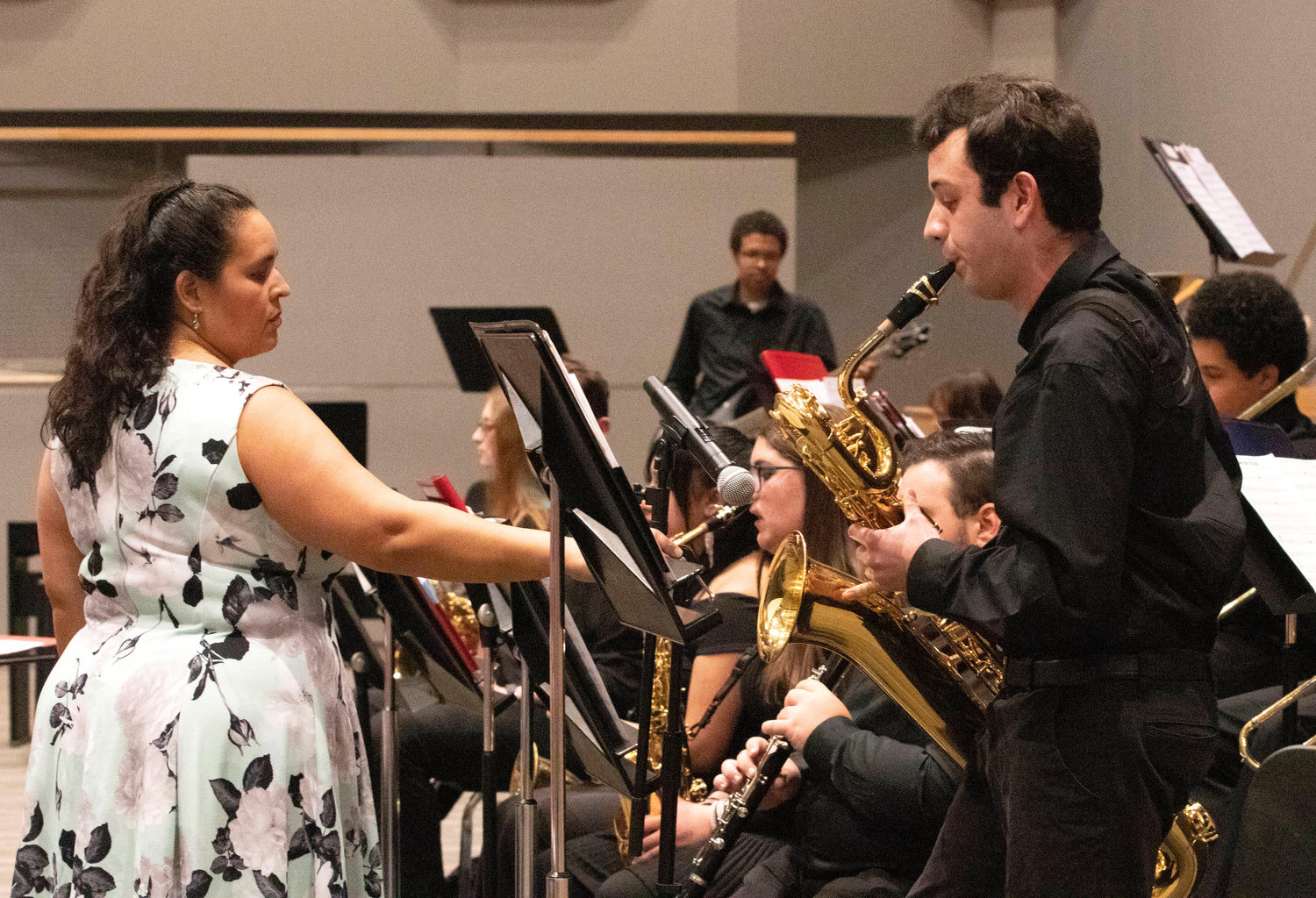 Band director Marisa Silva (left) holds a stand while James Davey plays a solo on the baritone sax