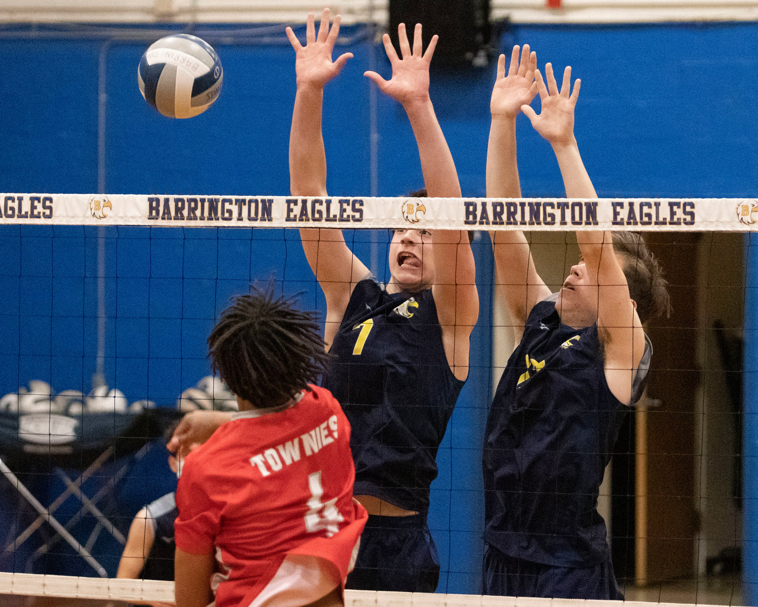 A pair of Barrington volleyball players try to block an East Providence shot.