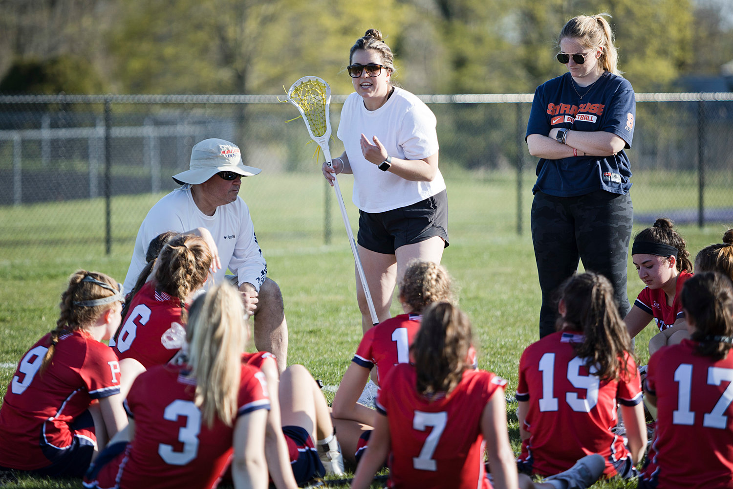 Portsmouth head coach Amelia McHugh talks strategy with her team at halftime.