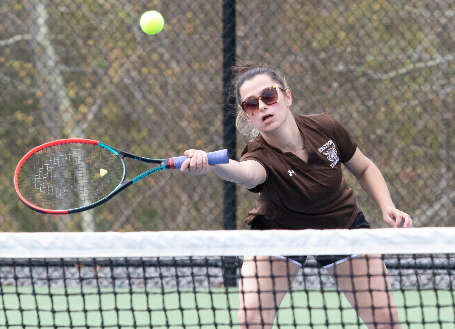Mikhaela Rego hits a volley at the net, during the team’s match against Diman.