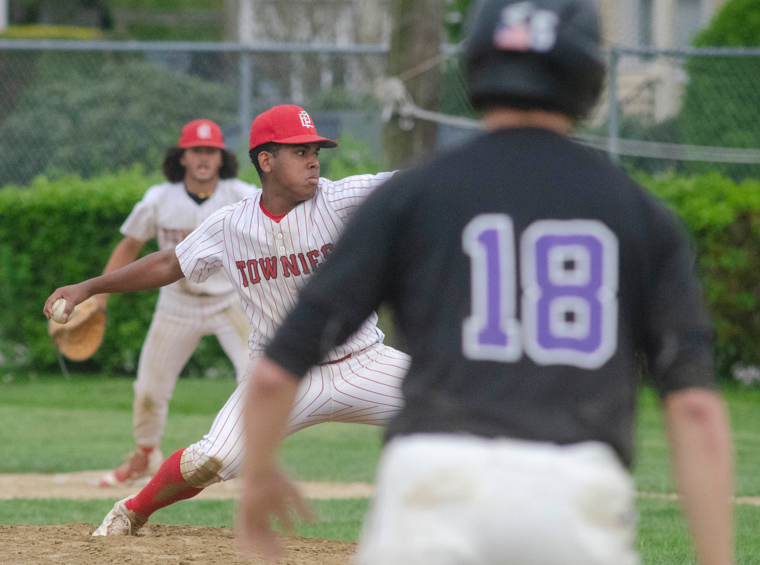 Junior pitcher Ziurel Vargas rears back to pitch with the Townies clinging to a 9-8 lead and Huskies runner Matt Gale on third base in the seventh inning.