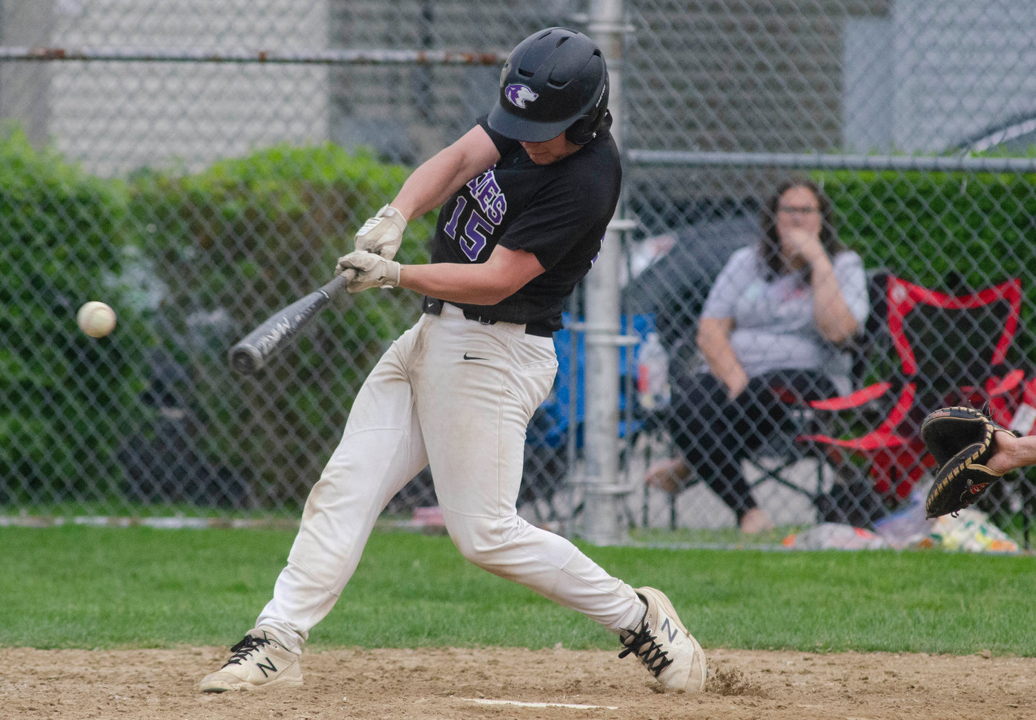 Senior catcher Jack Standish smacks one of his three hits during the game. Standish went three for four and drove in two runs for the Huskies.