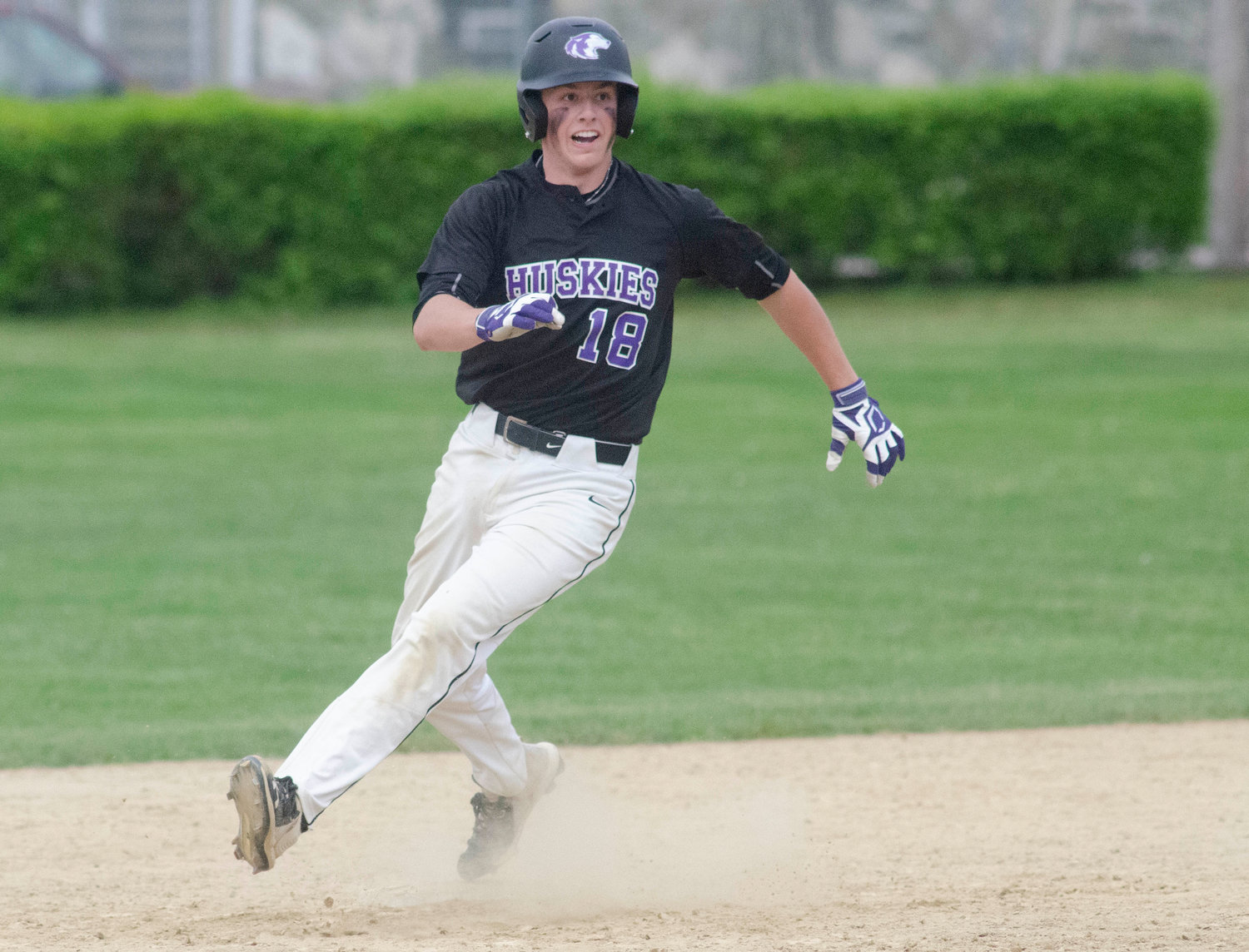First baseman Matt Gale rounds second base after smashing a towering hit to right field for a triple to start off the bottom of the seventh inning with the Huskies down 9-8. Gale looked to head coach Mike Mazzarella as he rounded second base and slid into third base safely.