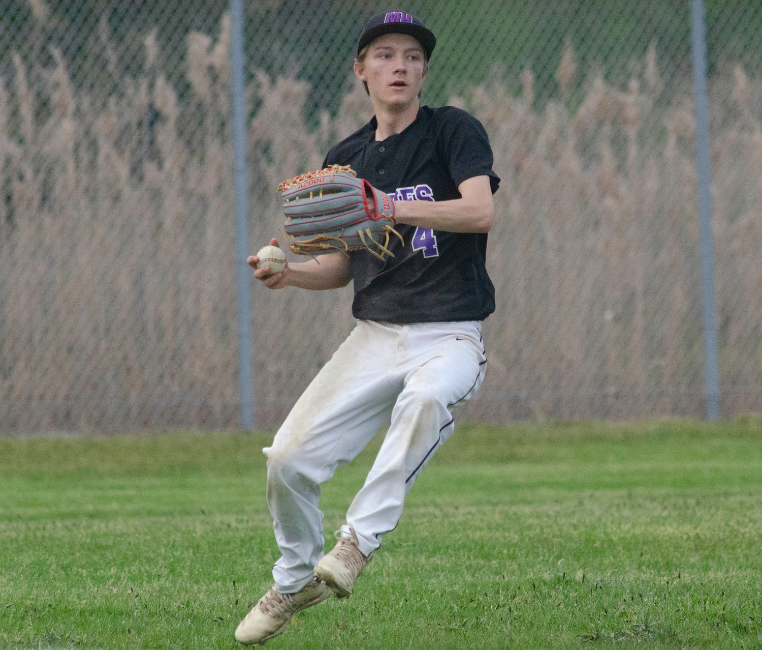 Mt. Hope left fielder Caleb DeCastro throws the ball in after retrieving an East Providence hit.