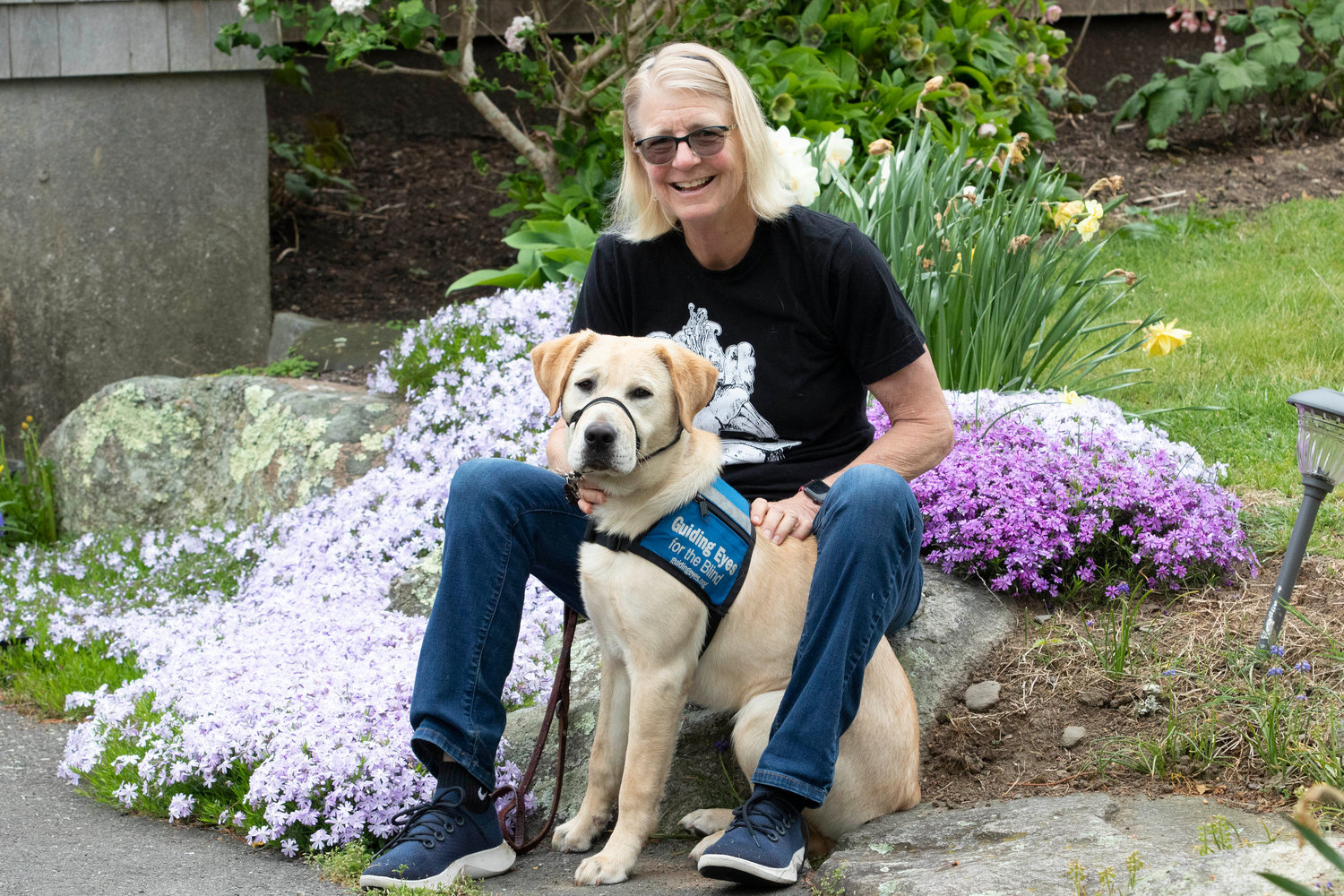 Perky Nellissen and 8-month-old Ziti pose together at their Little Compton home. Nellissen and Ziti are both going through guide dog training for the first time.
