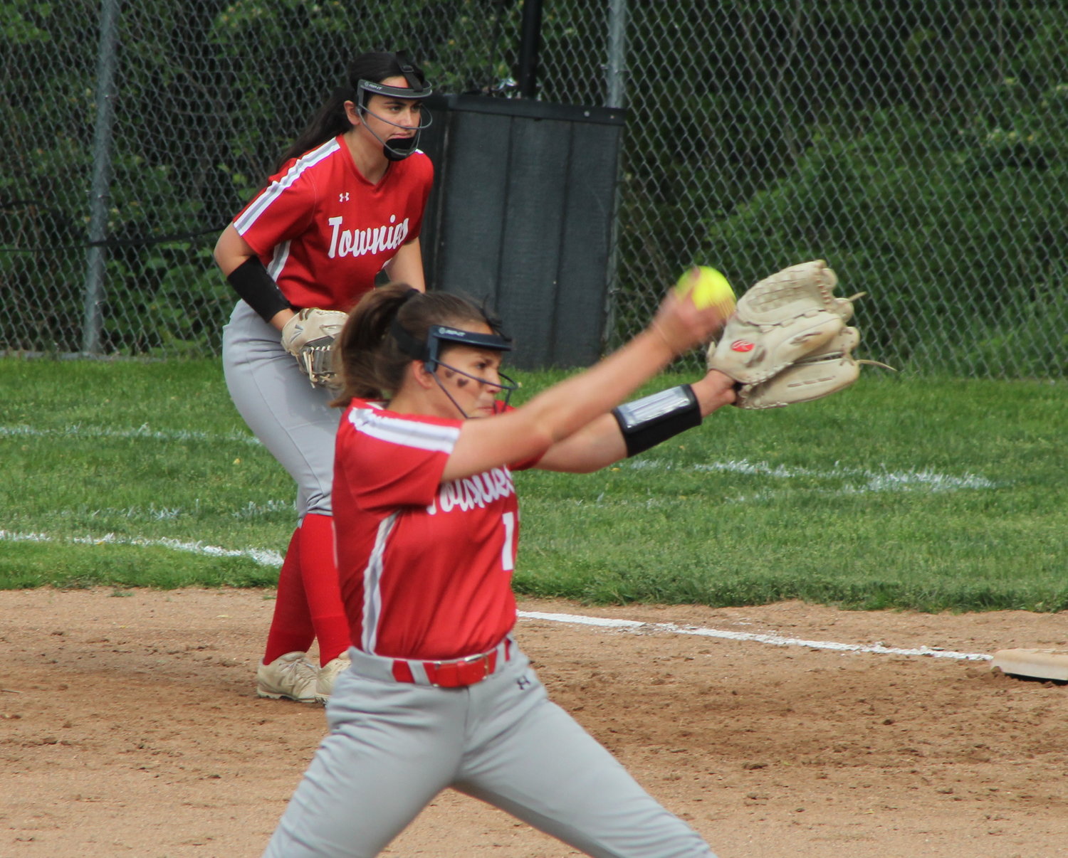 EPHS pitcher Keira Quadros delivers as first baseman Emma Bergeron gets into position for the Townies in their recent outing at neighboring Bay View.