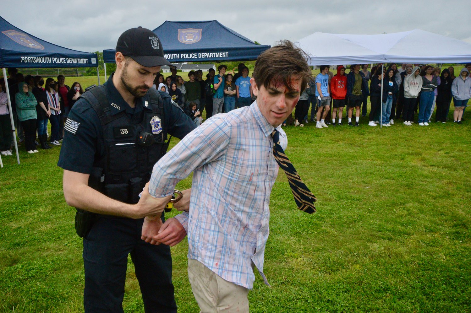 Jackson Benner is “arrested” by Officer James Thulier after failing a field sobriety test during the mock DUI reenactment.