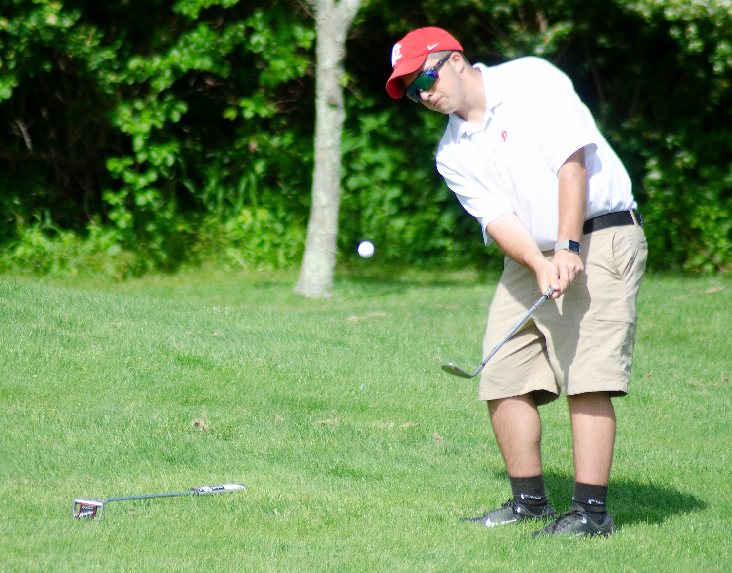 Zachary Mendo of East Providence chips onto the fifth green.