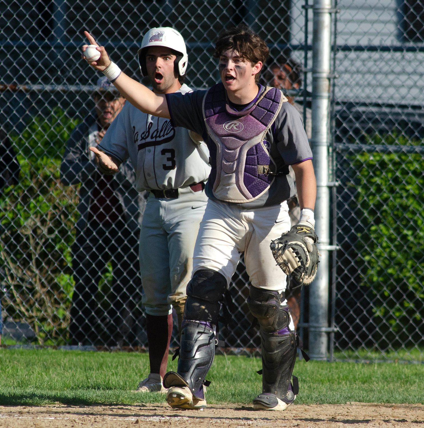 Senior catcher Jack Standish turns to see La Salle's Shea Caton slide by home plate without tagging it as the Ram tagged up at third base and ran home on a fly ball to right field. Standish walked over to Caton and tagged him out for the second out of the fifth inning.
