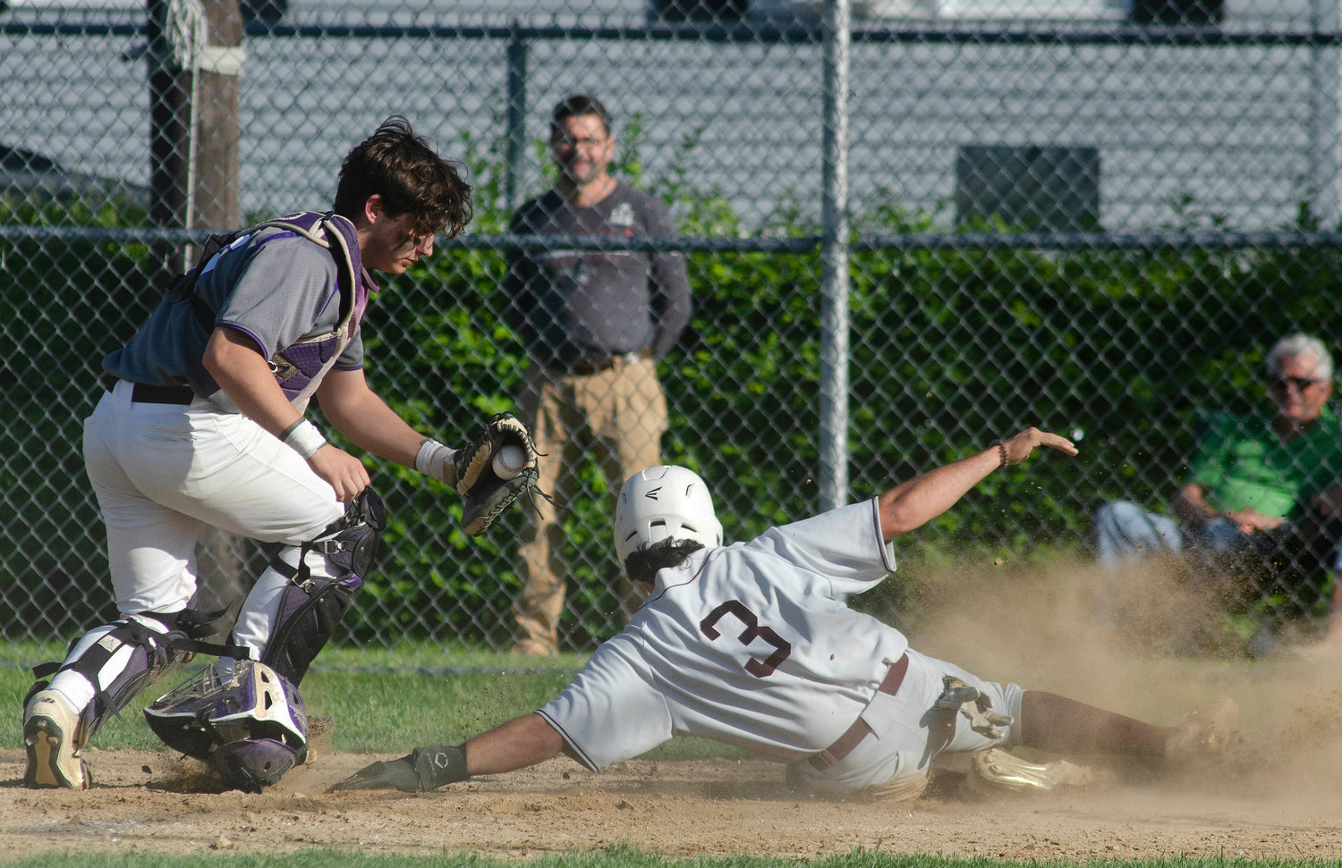 Senior catcher Jack Standish turns to see La Salle's Shea Caton slide by home plate without tagging it as the Ram tagged up at third base and ran home on a fly ball to right field. Standish walked over to Caton and tagged him out for the second out of the fifth inning.