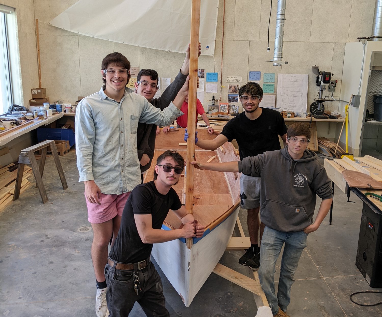 Students Riley Flannagan, Ben Poitras, Zander Santos, Matt Smith and Kenny Ferrer seem pleased after they installed Osprey's mast for the first time.