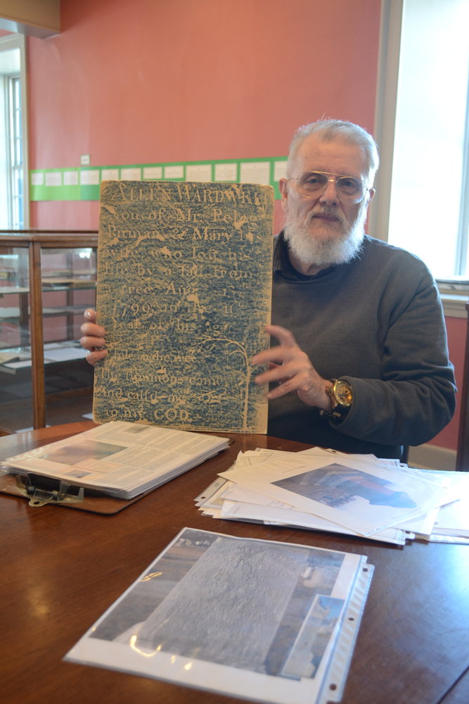 Rei Battcher, Historian/Librarian for the Bristol Historical and Preservation Society, holds up a gravestone rubbing of an interesting grave from the North Burial Ground, which tells the cautionary story of how a local 10-year-old boy, Allen Wardwell, lost their life after falling from a tree.