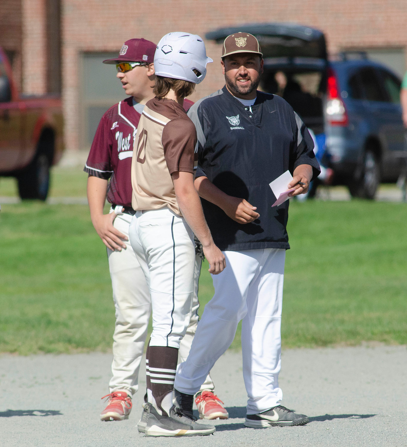 Coach Jason Pacheco speaks to Noah Sowle on second base during a West Bridgewater pitching change.