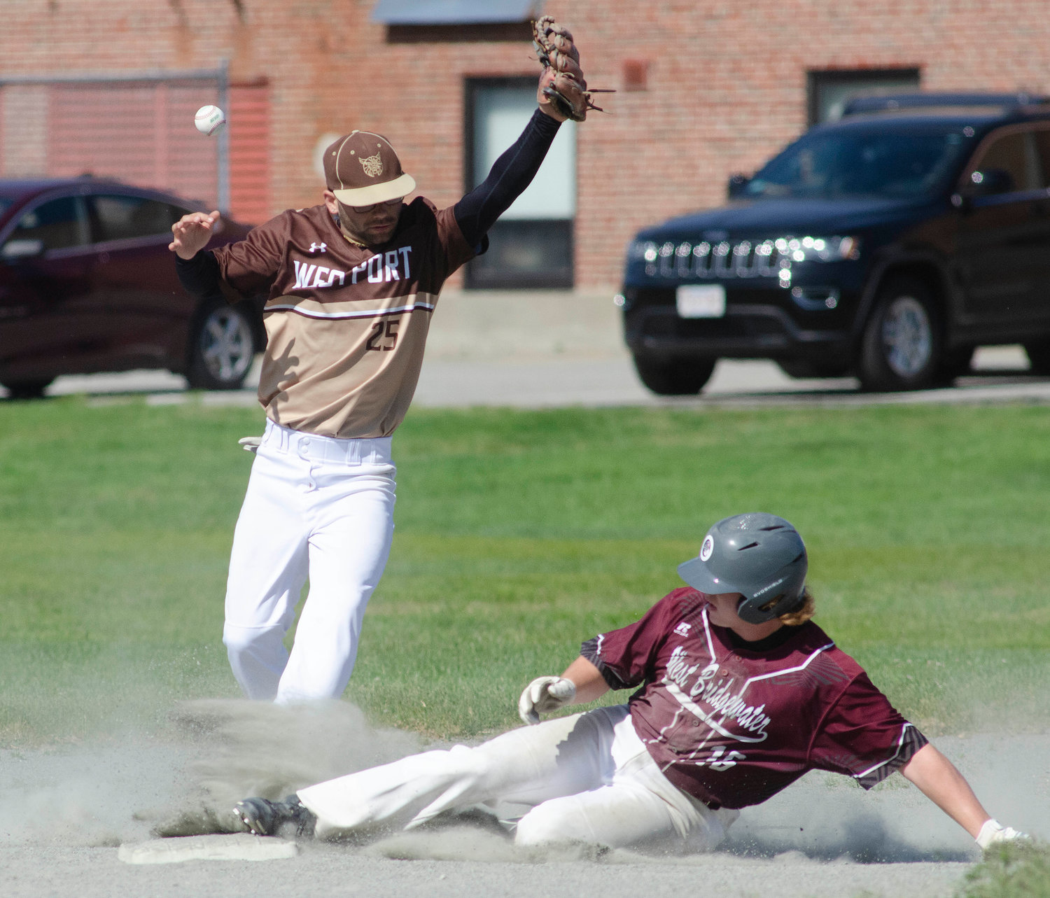Second baseman Nick Arruda attempts to snare a throw as a West Bridgwater base runner steals second base.