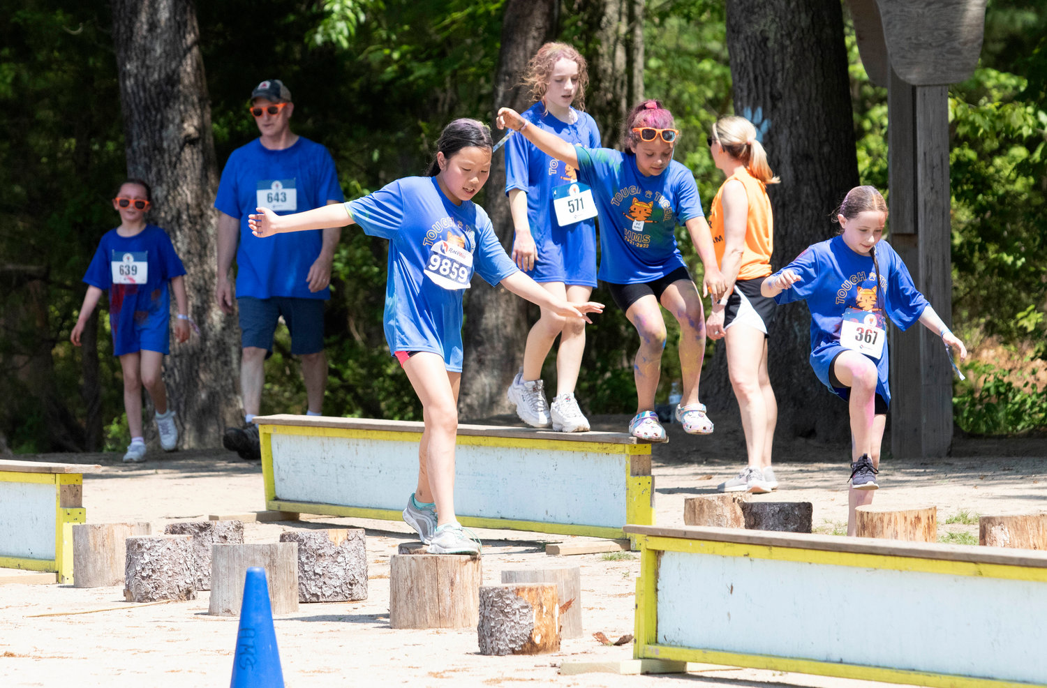Competitors navigate balance beams and stump steps during the Tough Tiger adventure race on Sunday.