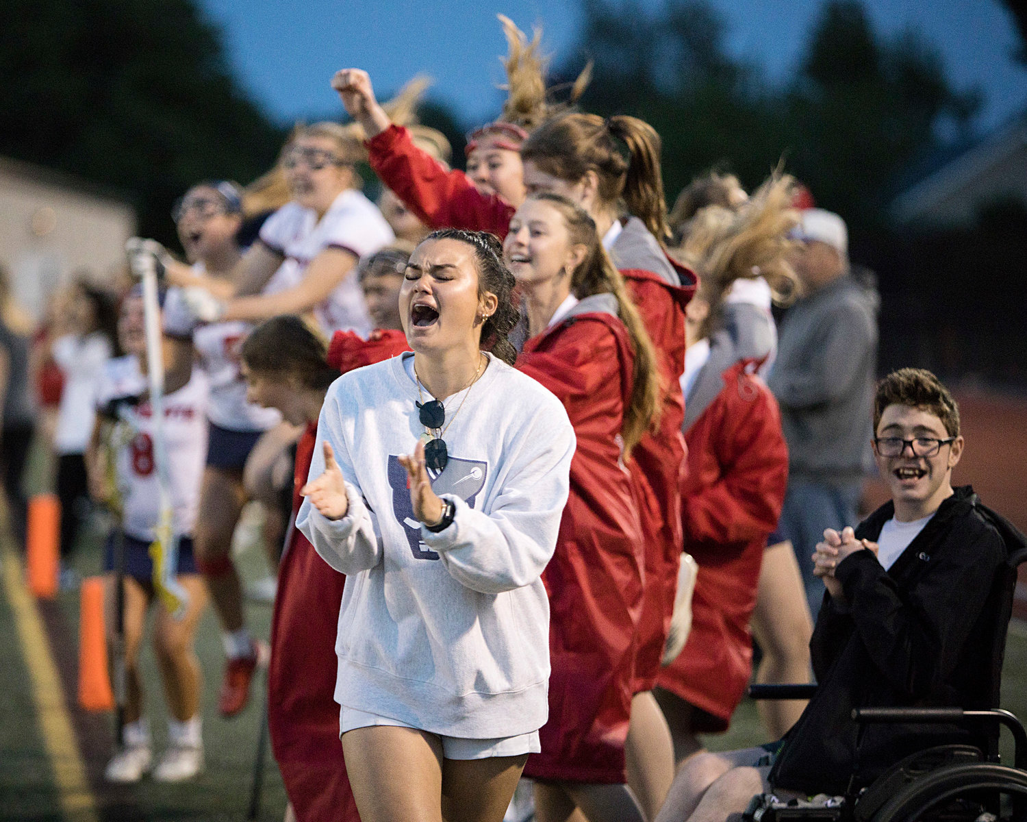 Players on the sideline cheer as the Patriots take the lead late in the second half of the Division II semifinals.