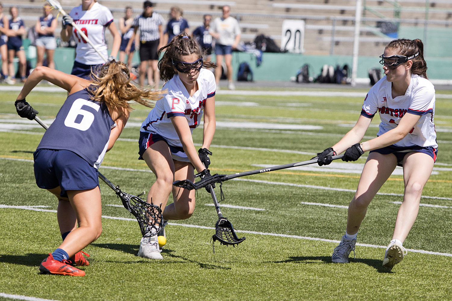 Margaux Boneu (left) and Nora Cooney battle a Burrillville opponent for possession of the ball.