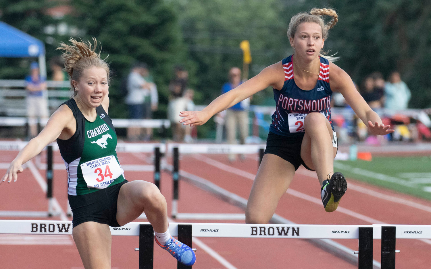 Marin Goodfriend (right) completes in a hurdles event.